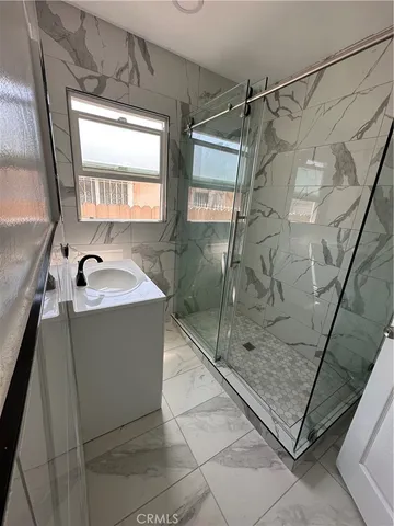 a bathroom with a shower and mirror