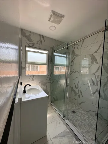 a bathroom with a sink and a shower