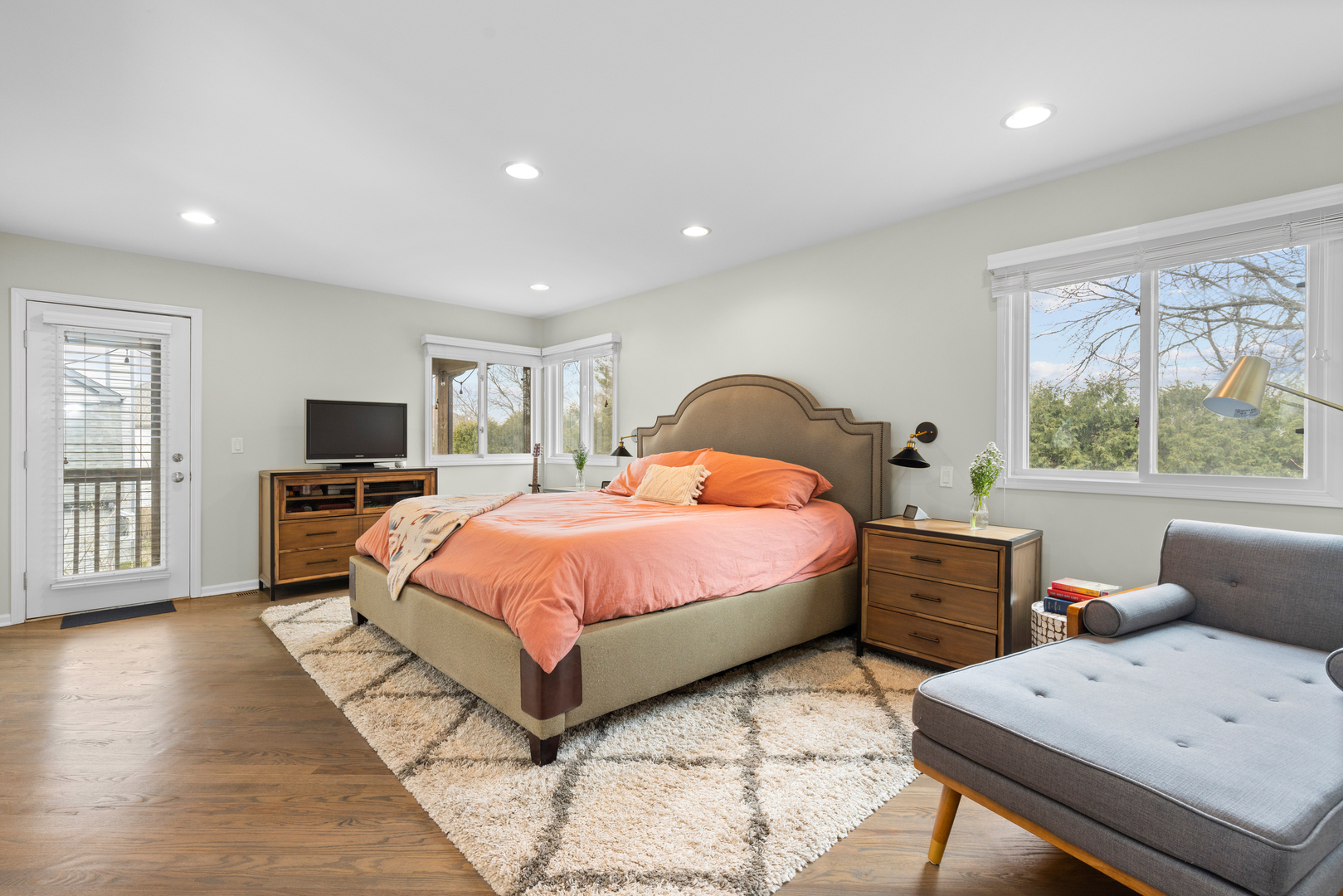 607 Raintree Road Buffalo Grove, IL 60089 - Photo 13 of 27 a spacious bedroom with a bed and a flat screen tv