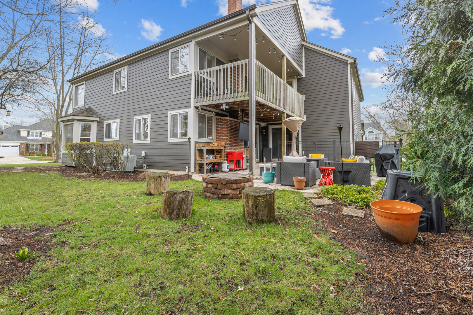 607 Raintree Road Buffalo Grove, IL 60089 - Photo 25 of 27 a backyard of a house with fire pit and outdoor seating