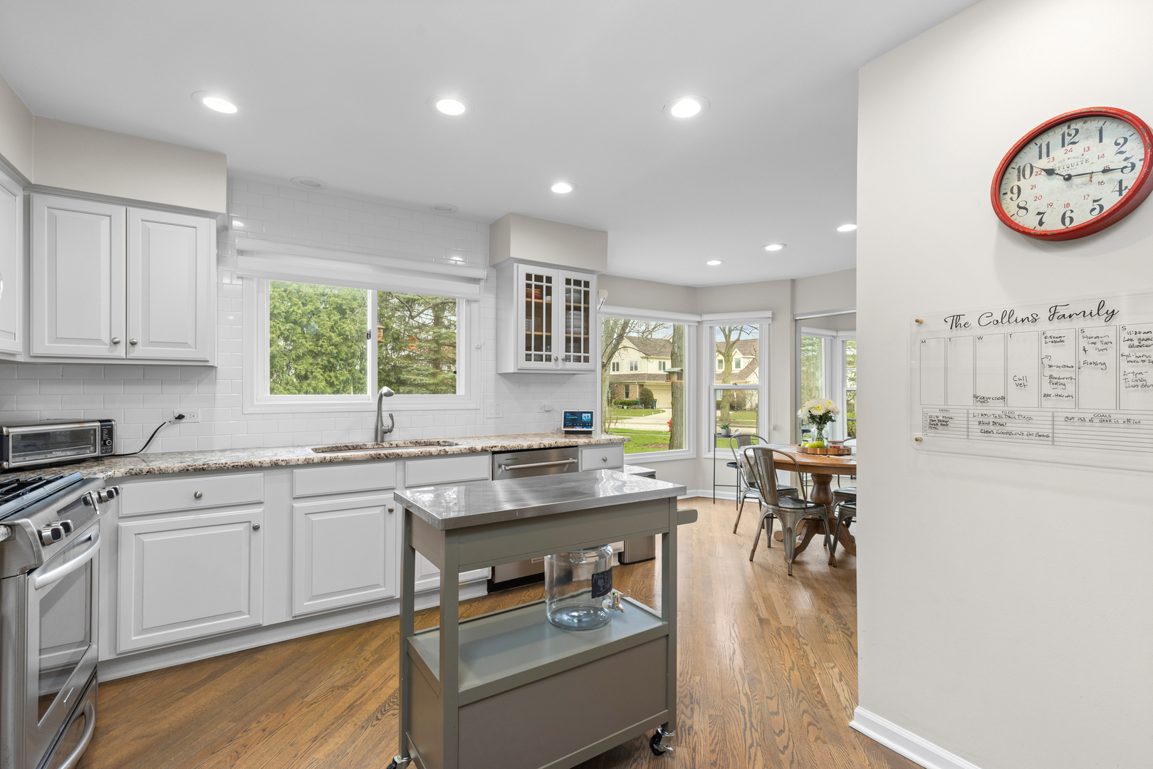 607 Raintree Road Buffalo Grove, IL 60089 - Photo 9 of 27 a large kitchen with a table and chairs in it
