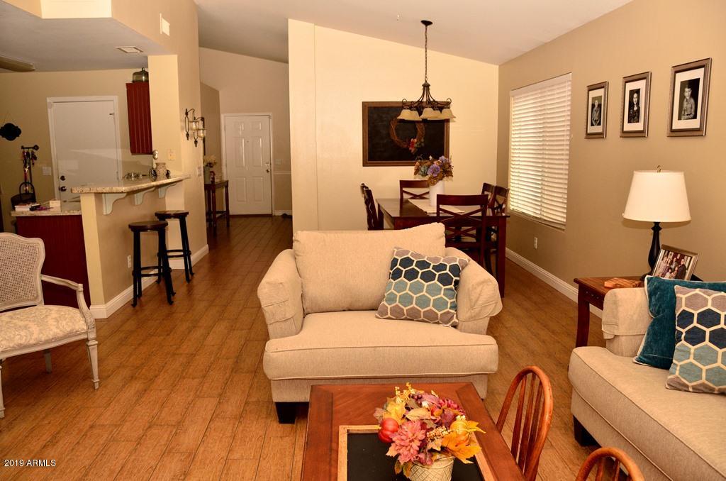 5101 Casper Road Mesa, AZ 85205 - Photo 17 of 17 a living room with furniture a flat screen tv and a fireplace