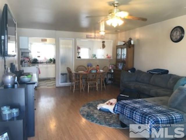 745-747 Apple Street Reno, NV 89502 - Photo 14 of 19 a living room with furniture a dining table and a chandelier