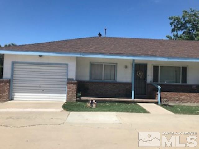 745-747 Apple Street Reno, NV 89502 - Photo 2 of 19 a front view of a house with a yard and garage