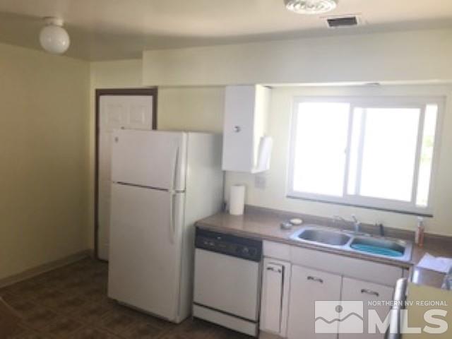 745-747 Apple Street Reno, NV 89502 - Photo 9 of 19 a white refrigerator freezer sitting inside of a kitchen