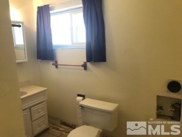 745-747 Apple Street Reno, NV 89502 - Photo 10 of 19 a bathroom with a toilet a sink and a window