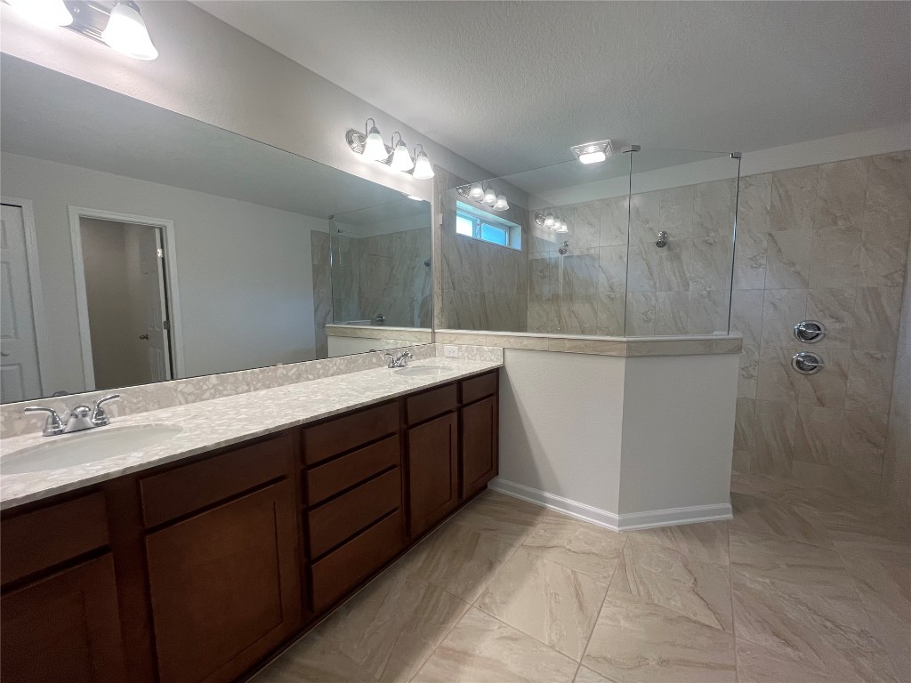 96754 Quartz Lane Yulee, FL 32097 - Photo 16 of 23 a bathroom with a double vanity sink a and a mirror