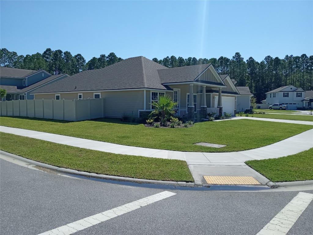 96754 Quartz Lane Yulee, FL 32097 - Photo 19 of 23 a view of a house with a garden and yard