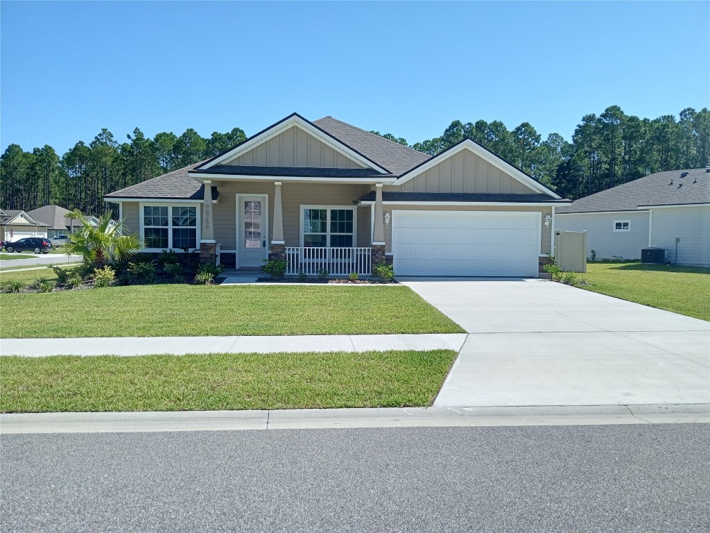 96754 Quartz Lane Yulee, FL 32097 - Photo 20 of 23 a front view of a house with a yard