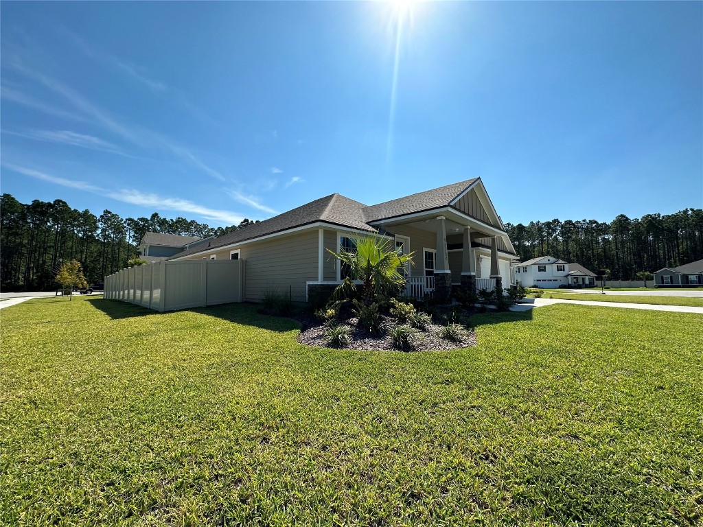 96754 Quartz Lane Yulee, FL 32097 - Photo 2 of 23 a view of a house with a yard