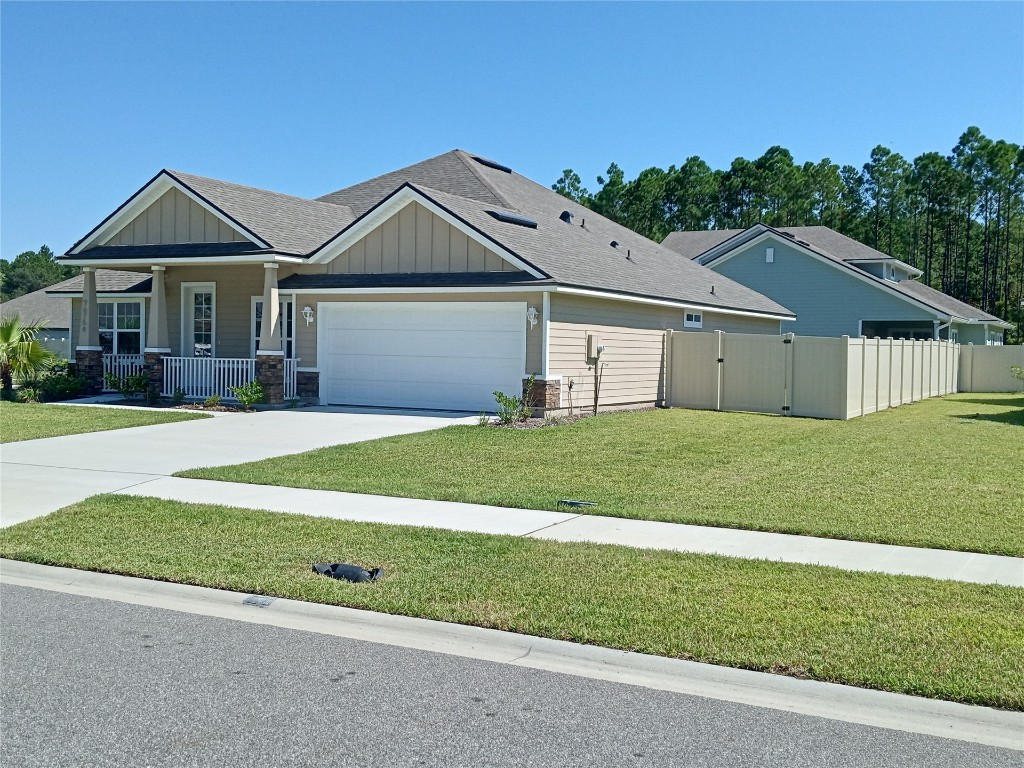 96754 Quartz Lane Yulee, FL 32097 - Photo 21 of 23 a front view of a house with a garden