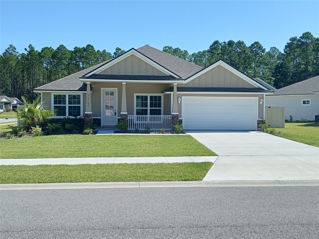 96754 Quartz Lane Yulee, FL 32097 - Photo 23 of 23 a front view of a house with a garden and plants
