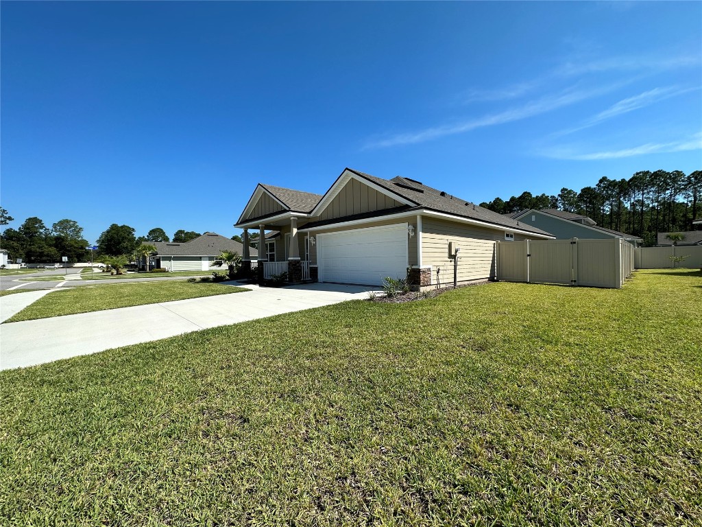 96754 Quartz Lane Yulee, FL 32097 - Photo 3 of 23 a front view of a house with a yard