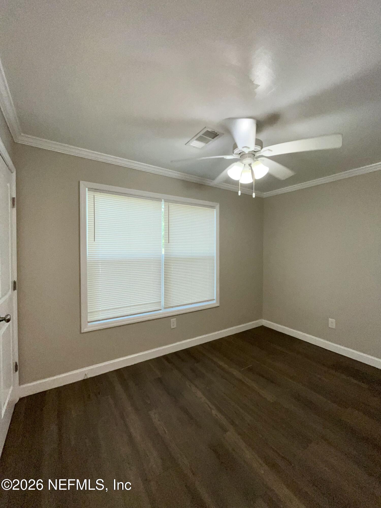2017 Talladega Road Jacksonville, FL 32209 - Photo 30 of 34 wooden floor in an empty room with a window