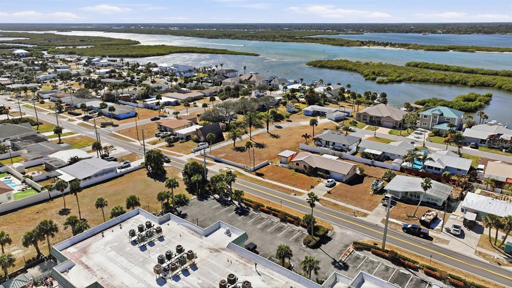 3816 Cardinal Boulevard Port Orange, FL 32127 - Photo 30 of 42 an aerial view of a city with lots of residential buildings ocean and mountain view in back