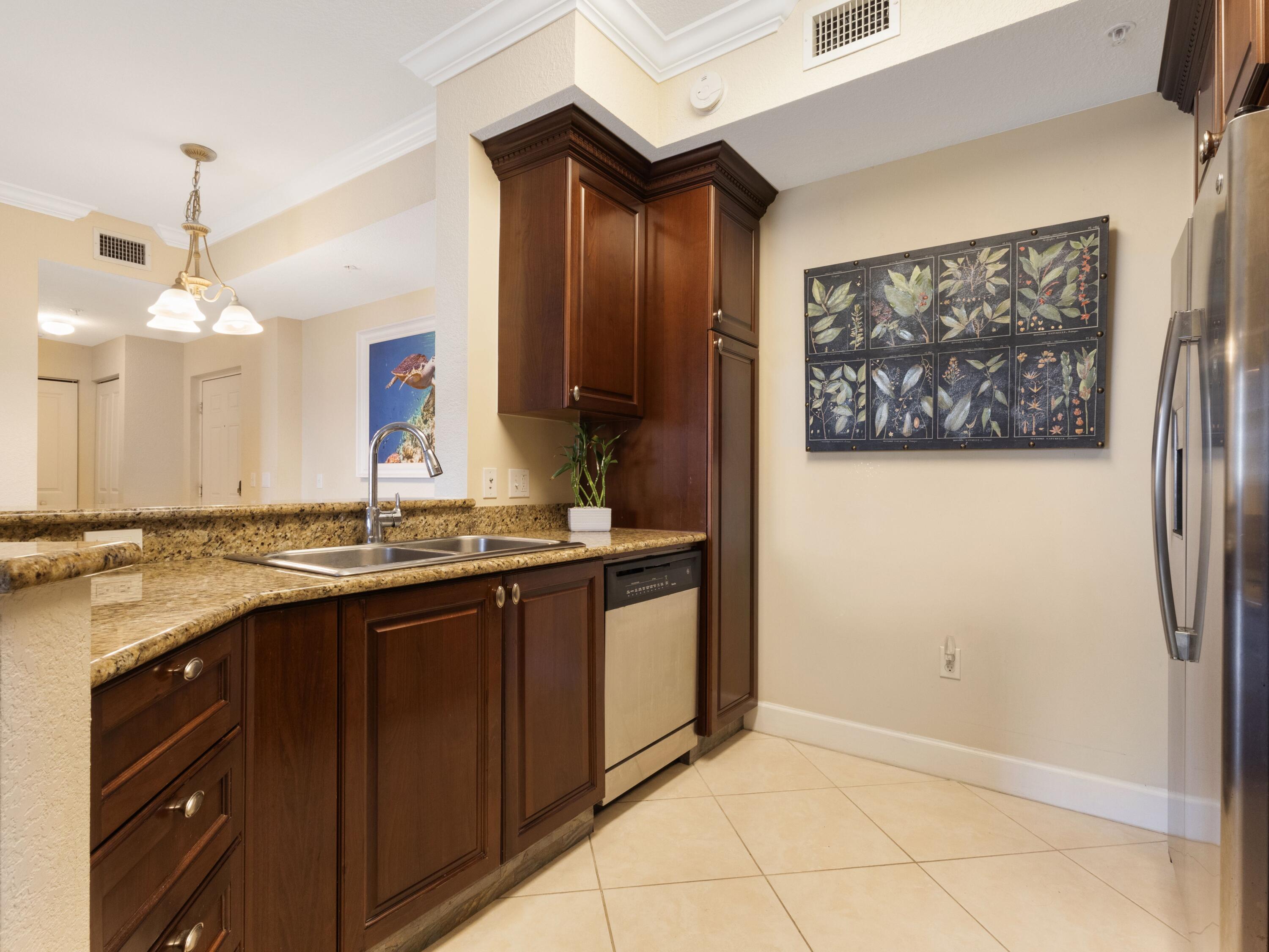 1690 Renaissance Commons Boulevard, Unit 1412 Boynton Beach, FL 33426 - Photo 6 of 49 a bathroom with a sink and a mirror