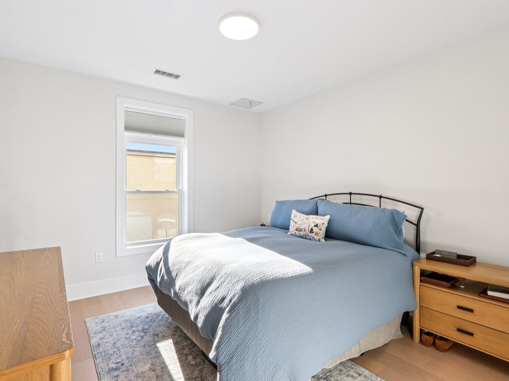 62 Foundry Street, Unit 204 Wakefield, MA 01880 - Photo 12 of 28 a bedroom with a bed and a window