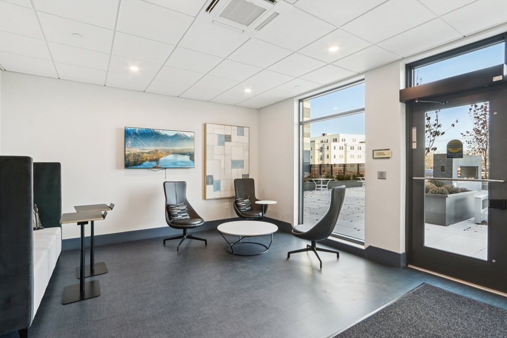 62 Foundry Street, Unit 204 Wakefield, MA 01880 - Photo 24 of 28 a living room with furniture a large window and glass door
