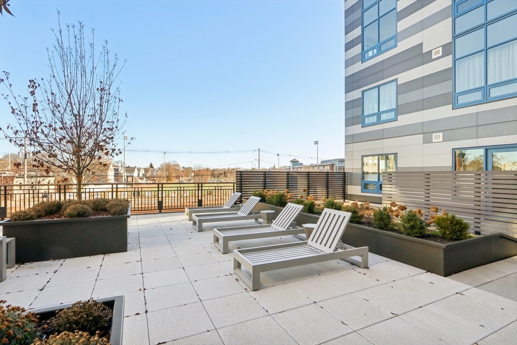 62 Foundry Street, Unit 204 Wakefield, MA 01880 - Photo 26 of 28 a roof deck with couches and potted plants