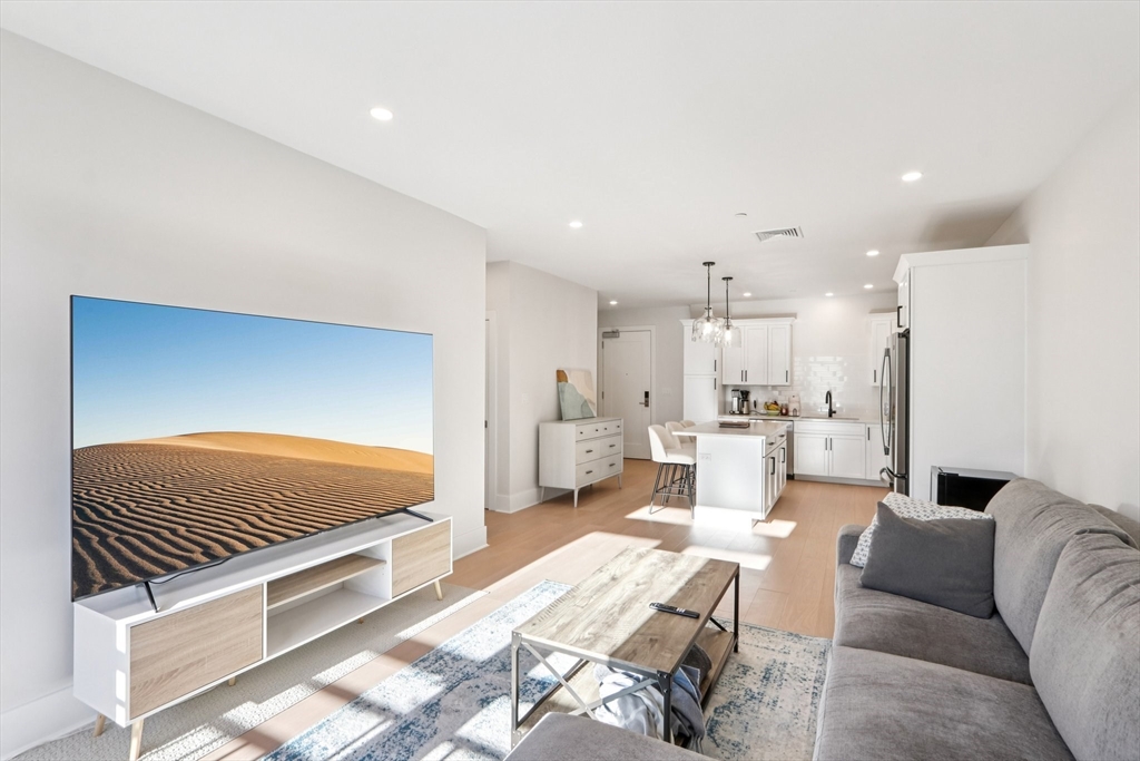 62 Foundry Street, Unit 204 Wakefield, MA 01880 - Photo 6 of 28 a living room with furniture and a couch