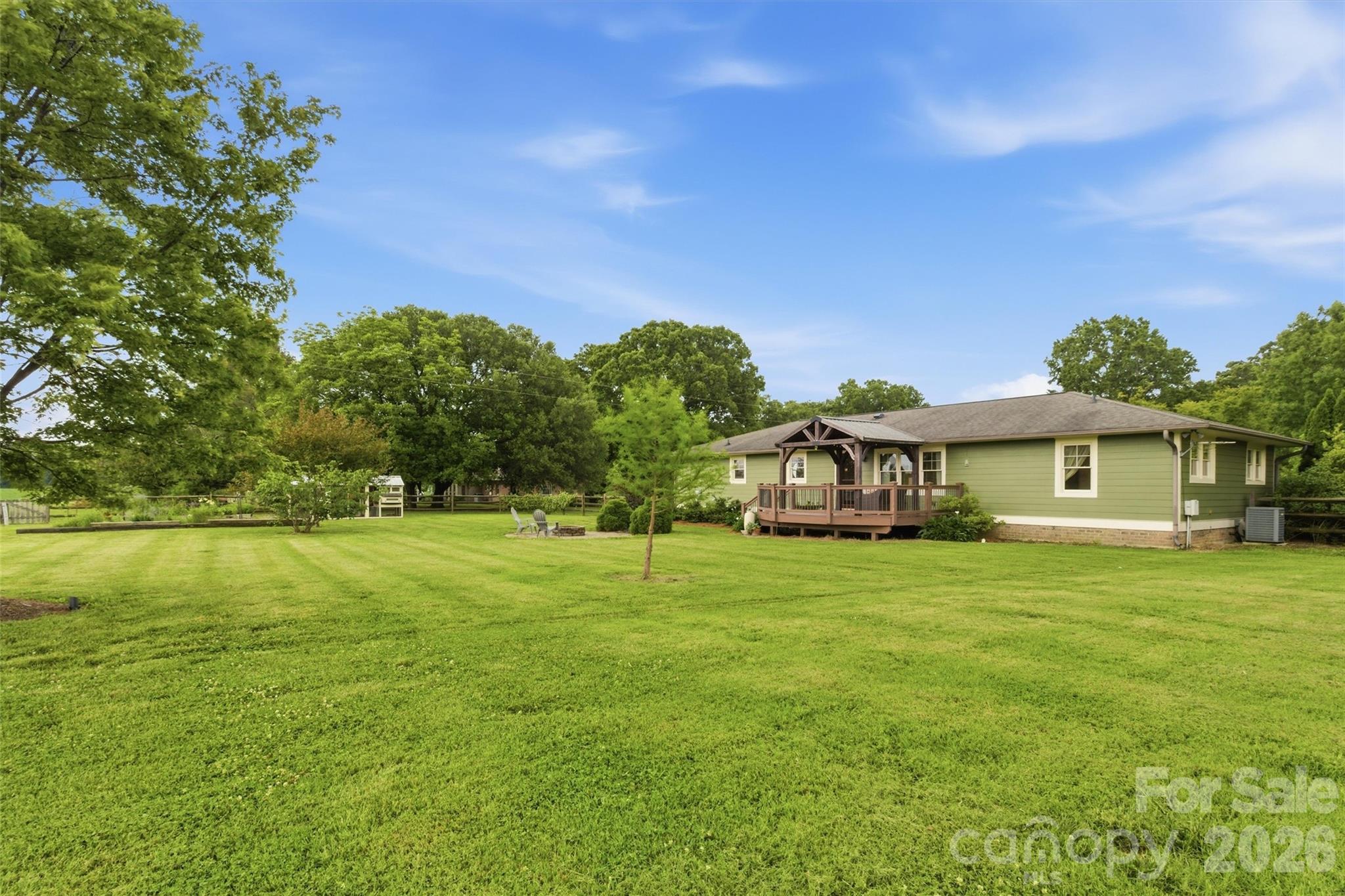 4712 Secrest Short Cut Road Monroe, NC 28110 - Photo 23 of 30 a front view of a house with a garden
