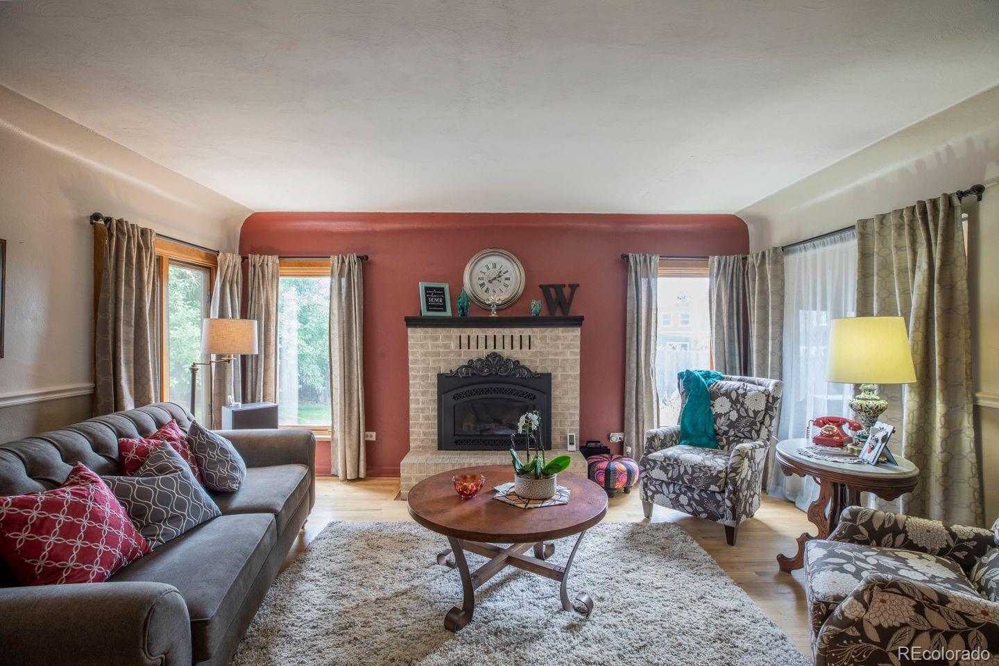 6101 South University Boulevard Centennial, CO 80121 - Photo 12 of 38 a living room with furniture and a fireplace