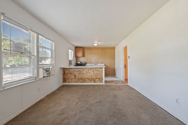 a view of a kitchen with a sink and a window