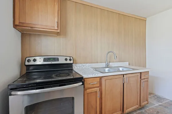 a view of a kitchen with a sink and cabinets