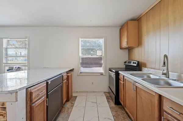 a kitchen that has a sink and a stove