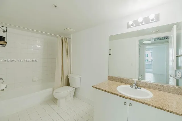 a white toilet sitting next to a bath tub