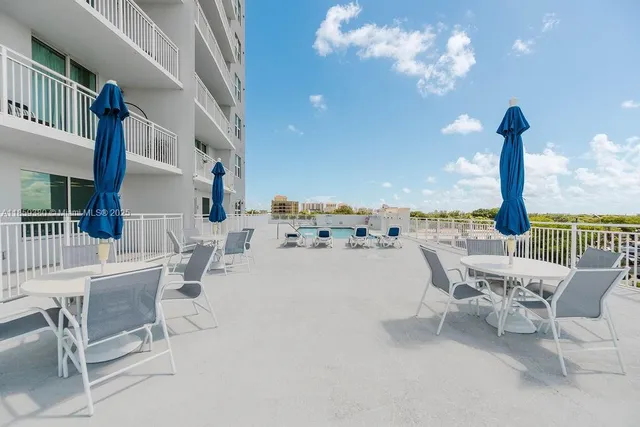 a view of a swimming pool with furniture