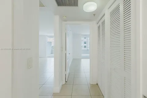 a bedroom with a bed a mirror and lamp