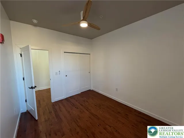 a view of empty room with wooden floor