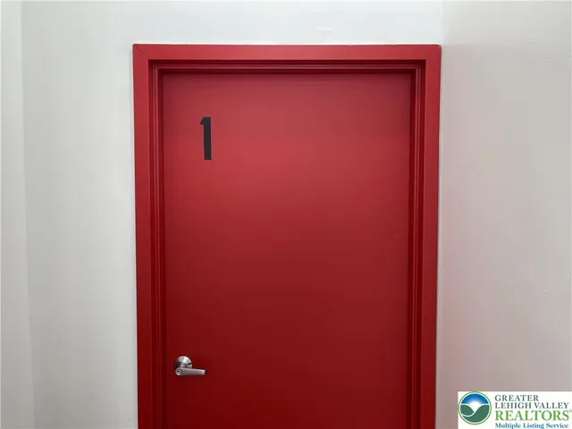 a open kitchen with stainless steel appliances granite countertop a refrigerator a stove a sink and a wooden floor