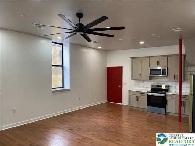 a kitchen with a refrigerator stove and microwave