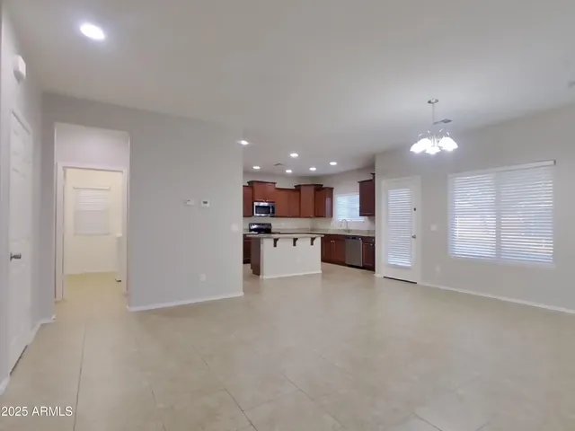 a view of an empty room with a kitchen
