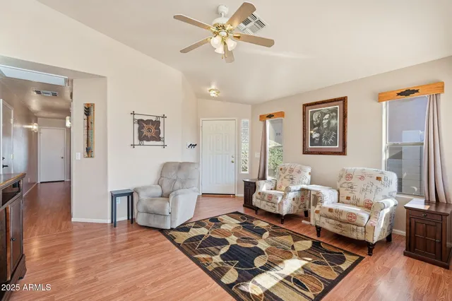 a living room with furniture and wooden floor