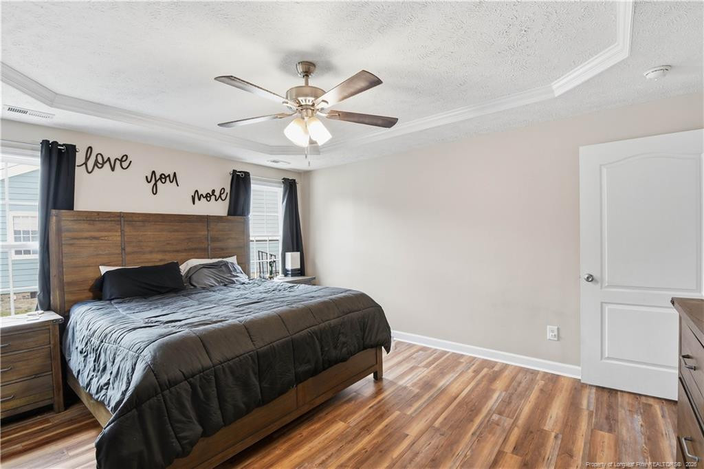212 Lennox Loop Raeford, NC 28376 - Photo 28 of 47 a bedroom with a bed and a chandelier