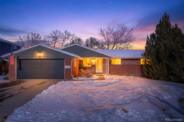 a view of a house with a yard and a garage