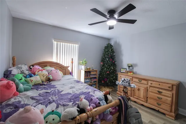 a bedroom with a bed and a dresser in it