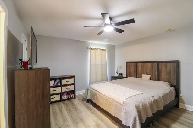 a bedroom with a bed dresser and a window