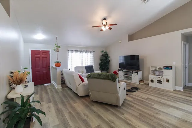 a living room with furniture and a flat screen tv