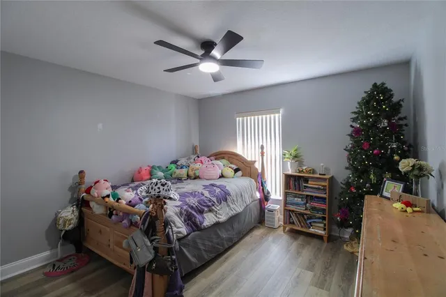 a bedroom with bed and a potted plant