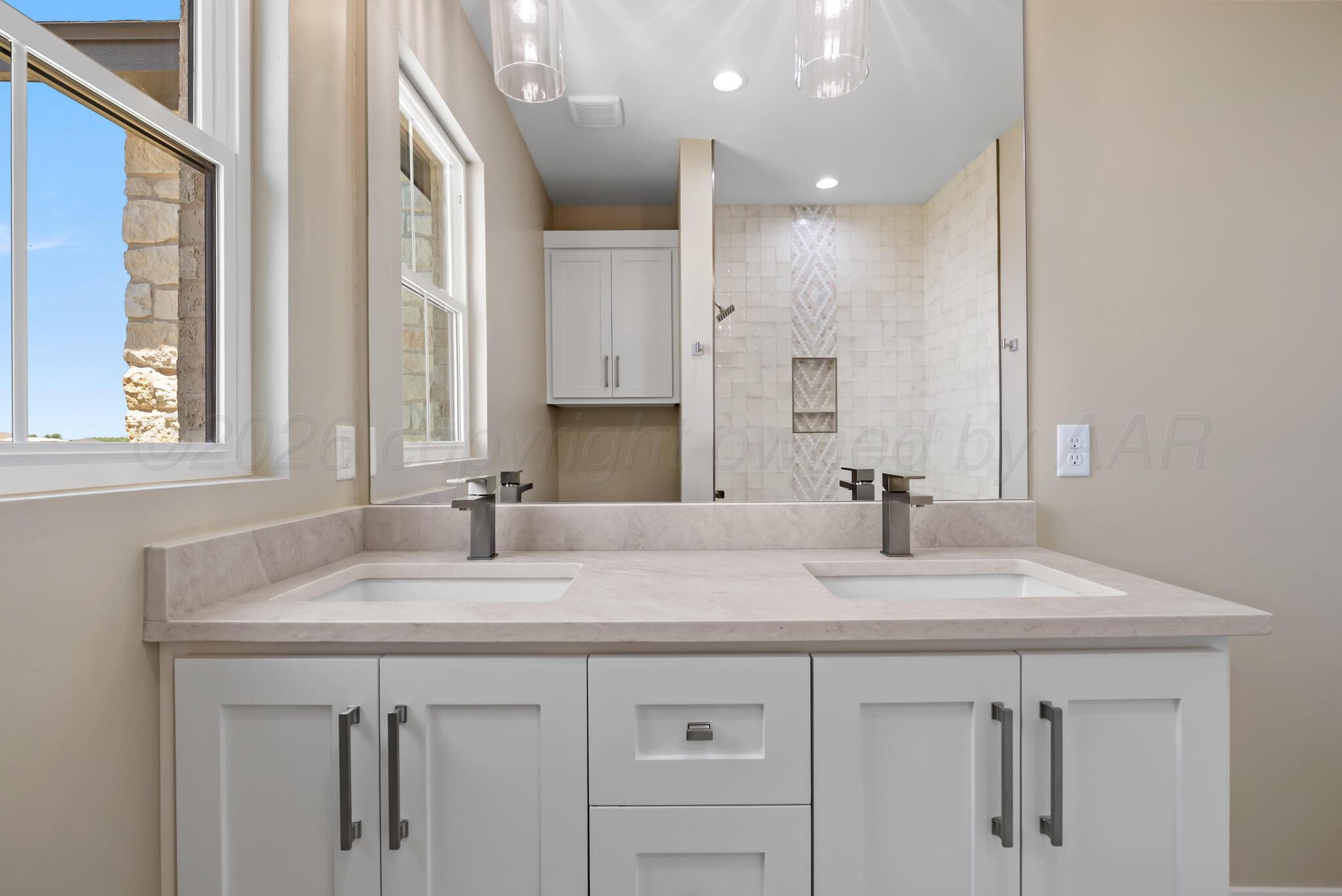4201 Juniper Springs Road Amarillo, TX 79119 - Photo 22 of 27 a sink with a granite countertop cabinets