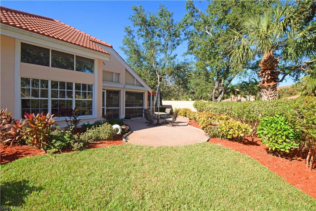 107 Napa Ridge Way Naples, FL 34119 - Photo 1 of 26 a front view of a house with garden