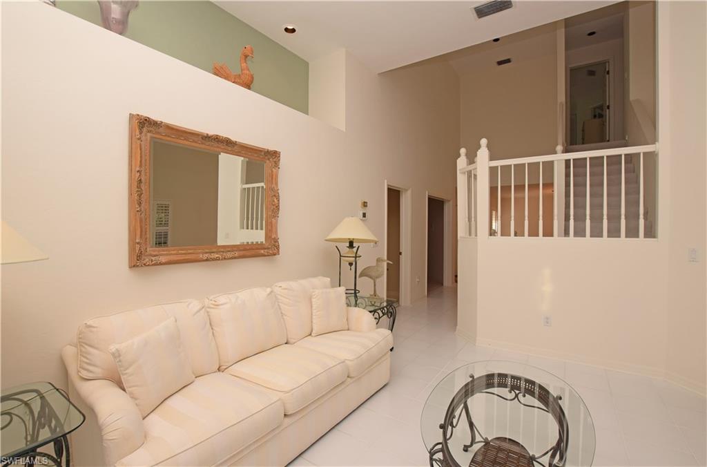 107 Napa Ridge Way Naples, FL 34119 - Photo 5 of 26 a living room with furniture and a window