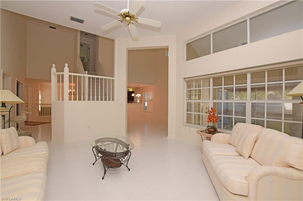 107 Napa Ridge Way Naples, FL 34119 - Photo 7 of 26 a living room with furniture and a large window