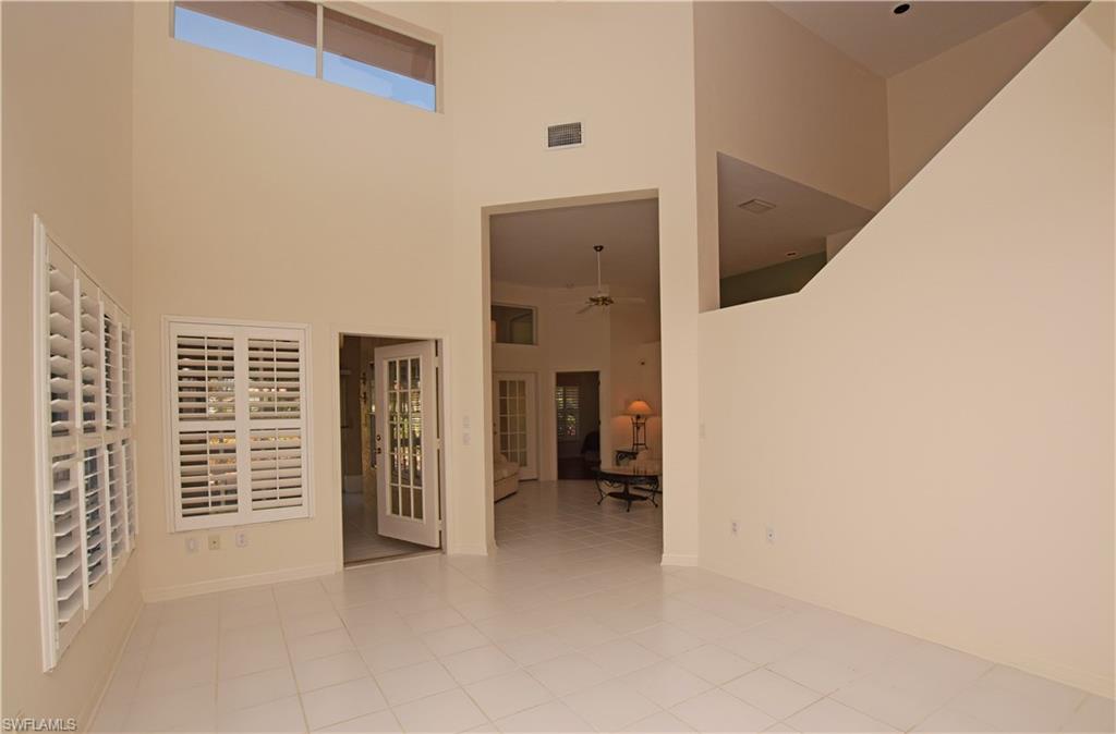 107 Napa Ridge Way Naples, FL 34119 - Photo 8 of 26 a view of an empty room with a fireplace
