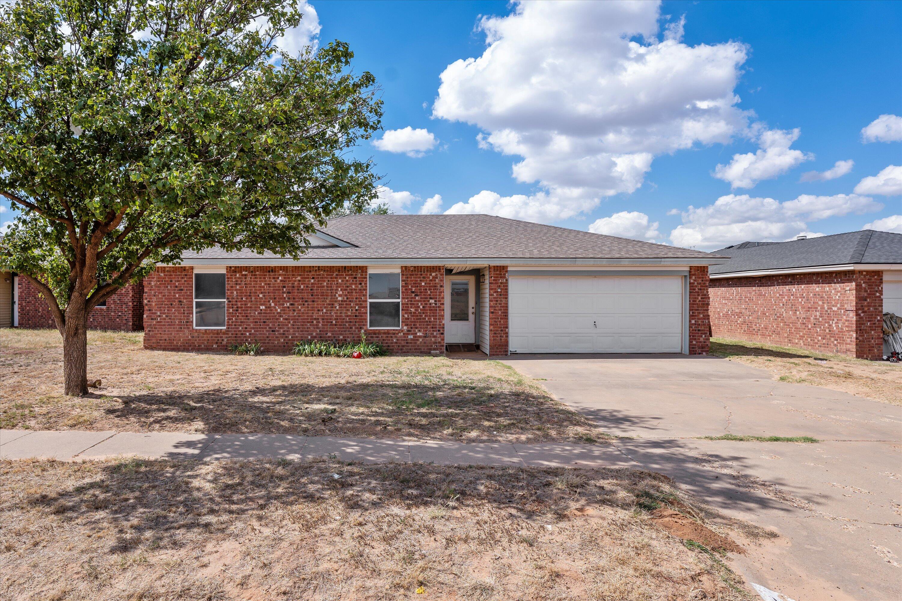 1605 Corpus Avenue Wolfforth, TX 79382 - Photo 1 of 20 a front view of a house with a yard and garage