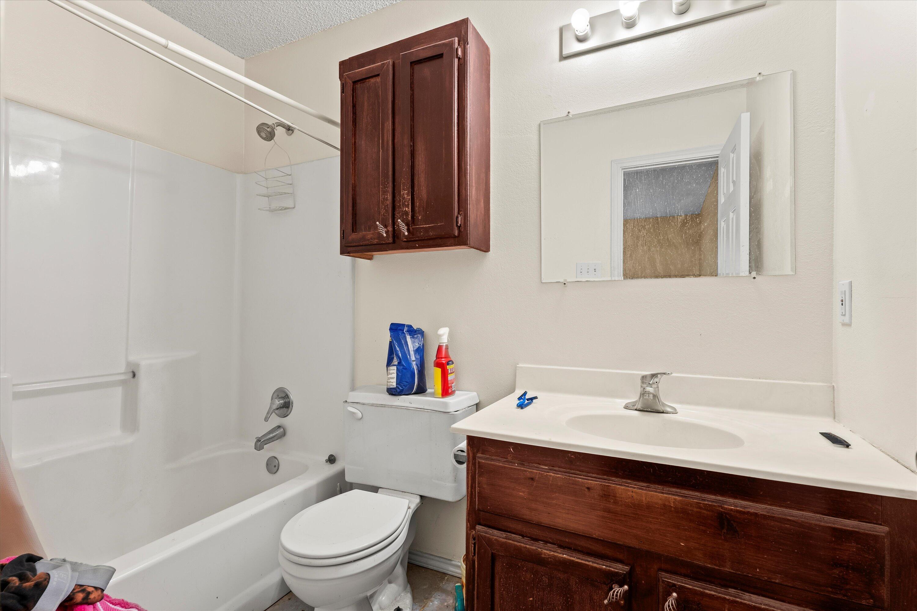 1605 Corpus Avenue Wolfforth, TX 79382 - Photo 11 of 20 a bathroom with a sink a toilet and shower